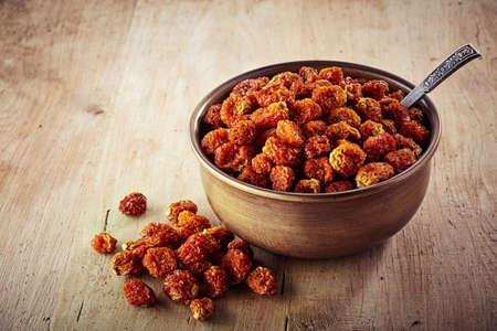 Bowl of dried cape gooseberries (physalis peruviana) on wooden backgroundの写真素材