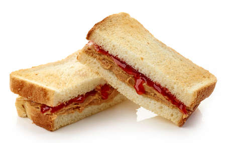 Peanut butter and strawberry jelly sandwich isolated on white backgroundの写真素材