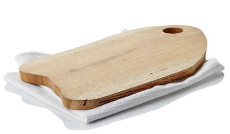 Brown wooden cutting board on cotton napkin isolated on white background. Clipping pathの写真素材
