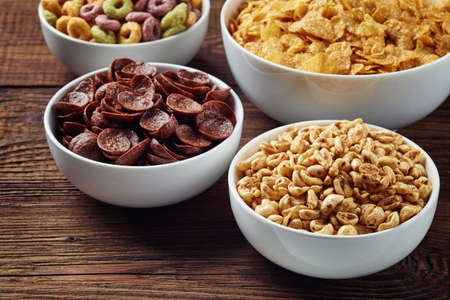 Bowls of various cereals on wooden backgroundの写真素材