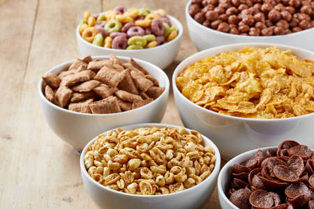 Bowls of various cereals on wooden backgroundの写真素材