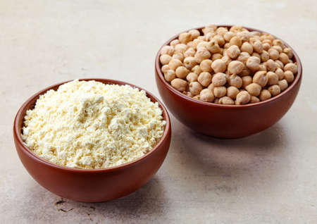 Bowl of chick peas flour and bowl of chick peas. Gluten freeの写真素材