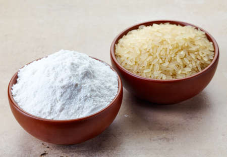Bowl of rice flour and bowl of rice. Gluten freeの写真素材