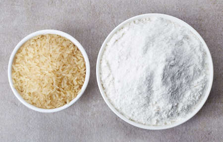 Bowl of rice flour and bowl of rice from top viewの写真素材