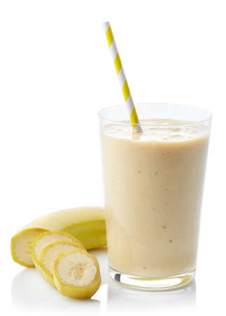 Glass of fresh healthy banana smoothie isolated on white backgroundの写真素材