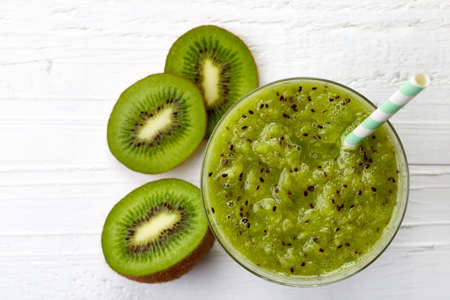 Glass of fresh healthy kiwi smoothie from top viewの写真素材