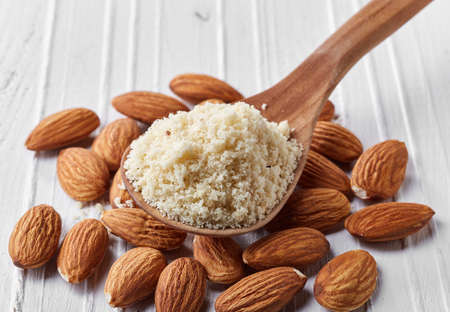 Spoon of almond flour on white wooden backgroundの写真素材