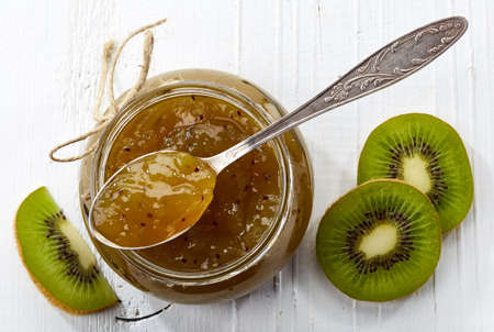 Jar of kiwi jam on white wooden background from top viewの写真素材