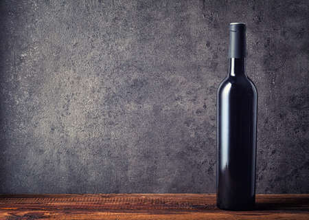 Bottle of red wine on dark backgroundの写真素材