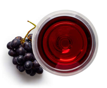 Glass of red wine and grapes isolated on white background from top view