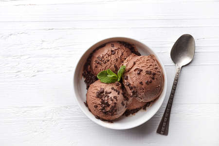 Bowl of chocolate ice cream on white wooden background. From top viewの写真素材