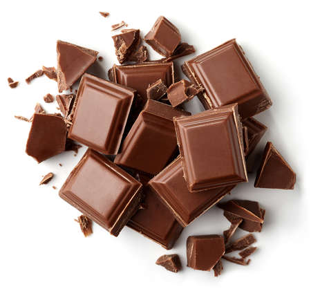 Milk chocolate pieces isolated on white background from top viewの写真素材