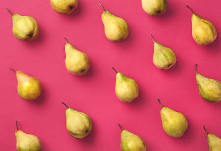 Colorful fruit pattern of fresh pears on pink background. From top viewの写真素材