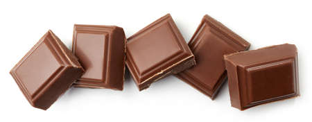 Milk chocolate pieces isolated on white background. Top viewの写真素材