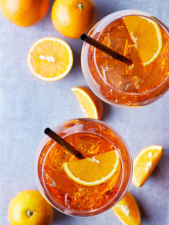 Two glasses of Aperol spritz cocktail with orange slices on marble background. Top viewの写真素材