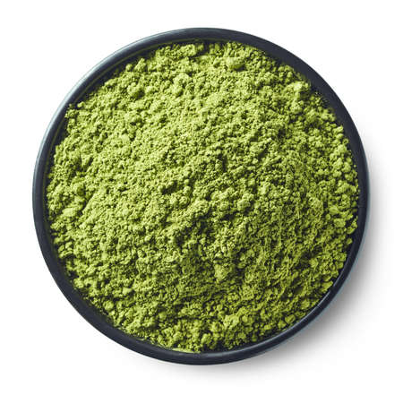 Black bowl of green matcha tea powder isolated on white background. Top viewの写真素材