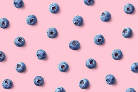 Colorful fruit pattern of blueberries on pink background. Top view. Flat lay