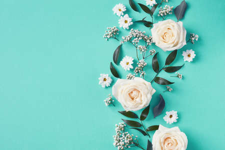 Beautiful white flowers composition on blue