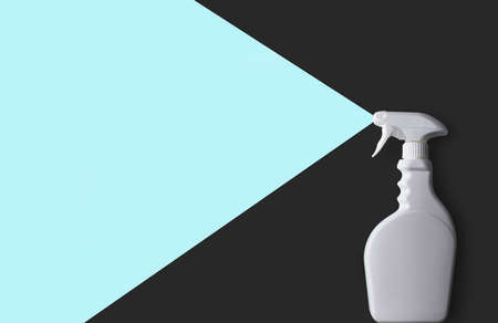 White plastic cleaning product bottle with spray on gray and blueの写真素材