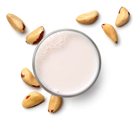 Glass of vegan brazil nut milk isolated on white background, top view. Dairy free, plant based drink.の写真素材