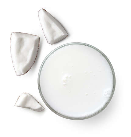 Glass of vegan coconut milk isolated on white background, top view. Dairy free, plant based drink.の写真素材