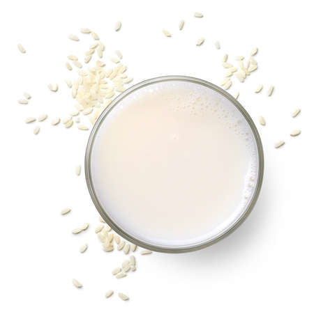 Glass of vegan rice milk isolated on white background, top view. Dairy free, plant based drink.の写真素材