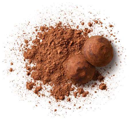 Heap of cocoa powder and chocolate truffles isolated on white background, top viewの写真素材