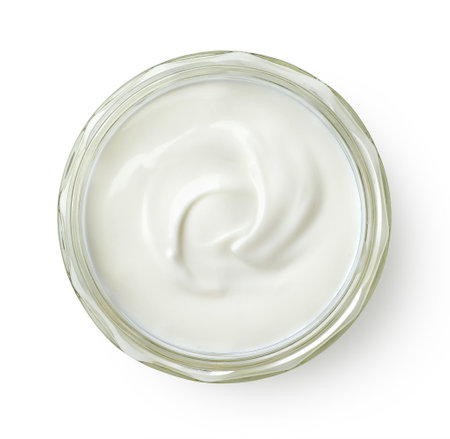 Glass jar of fresh greek yogurt isolated on white background, top viewの写真素材