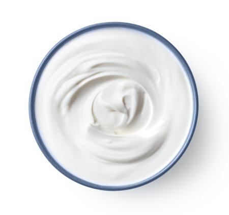 Blue ceramic bowl of fresh greek yogurt or sour cream isolated on white background, top viewの写真素材