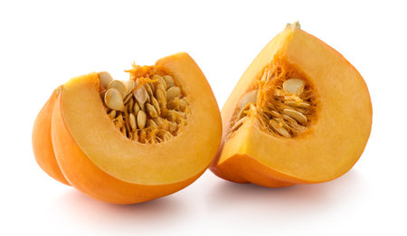 Two sliced pieces of fresh orange pumpkin isolated on white backgroundの写真素材
