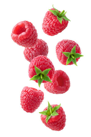 Various falling fresh ripe raspberries isolated on white background, vertical composition