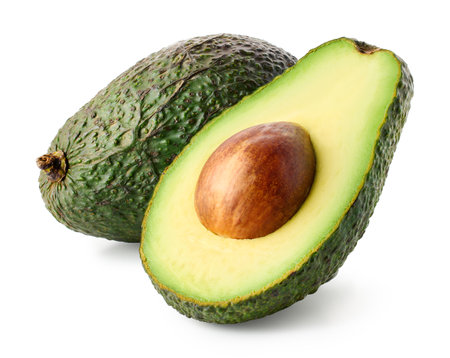 Whole and half of fresh green avocado isolated on white backgroundの写真素材