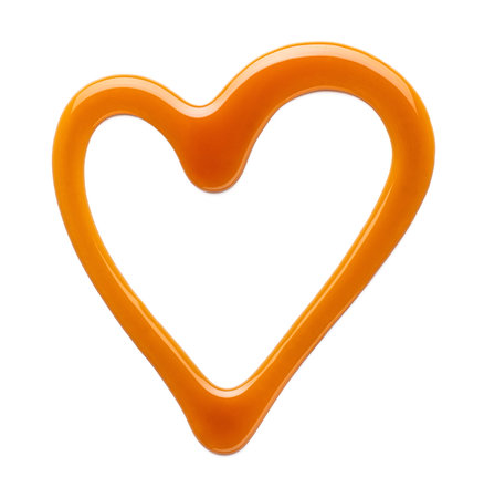 Heart shaped sweet caramel sauce isolated on white background, top viewの写真素材