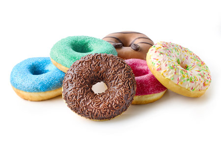Stack of different colorful donuts isolated on white backgroundの写真素材
