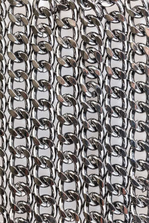 Abstract background of black decorative steel chain lying on a white background. Close-up.の写真素材