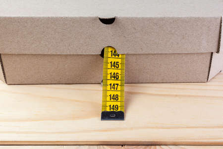 Yellow rag tape measure and pizza box. The concept of proper nutrition and weight loss.の写真素材