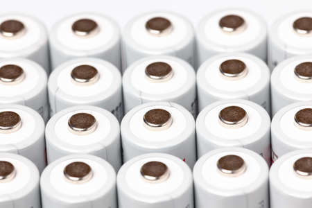 AA batteries are close to each other. Close-up of white batteries on a white background. Battery...