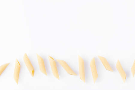 Raw feathers macaroni. Italian pasta close-up on the white background.の写真素材