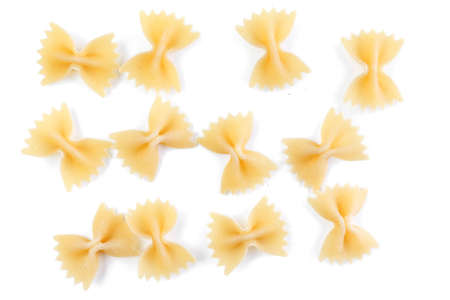 Variety of types and shapes of Italian pasta. Dry pasta background. A portion of Farfalle bows pasta...