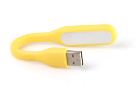 USB yellow plastic LED light lamp, isolated on a white background. Close-up.