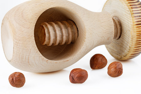 Traditional wooden nutcracker and hazelnuts on white background. closeup.の写真素材
