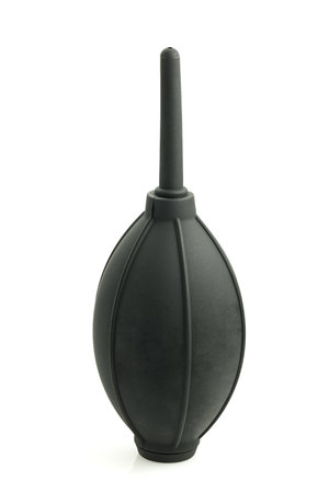 A rubber hand-held air pump for dust removal, isolated on a white background. This tool is designed...