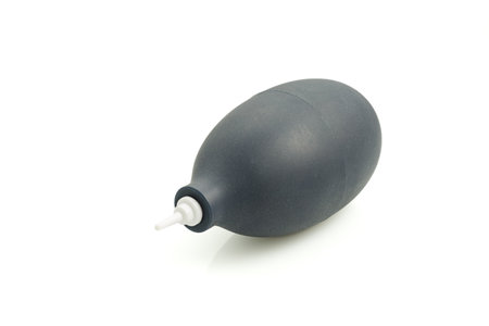 A rubber hand-held air pump for dust removal, isolated on a white background. This tool is designed for cleaning cameras, lenses, personal computers, keyboards, and mobile phones.の写真素材