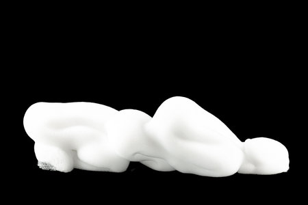 Soap foam, shaving foam, soap bubbles isolated on black background. Close up.の写真素材