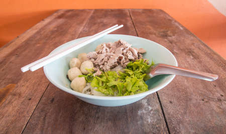Pork noodle on a wooden table