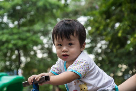 Boy playing swingの写真素材