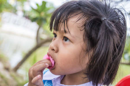Children eating candyの写真素材