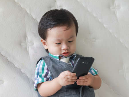 Kids playing phoneの写真素材