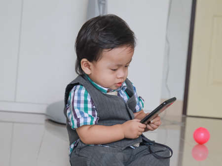 Kids playing phoneの写真素材