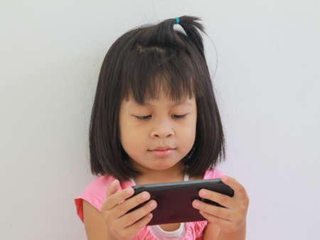 Kids playing phoneの写真素材